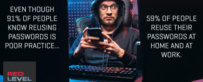 a man sitting in front of a computer keyboard holding his phone